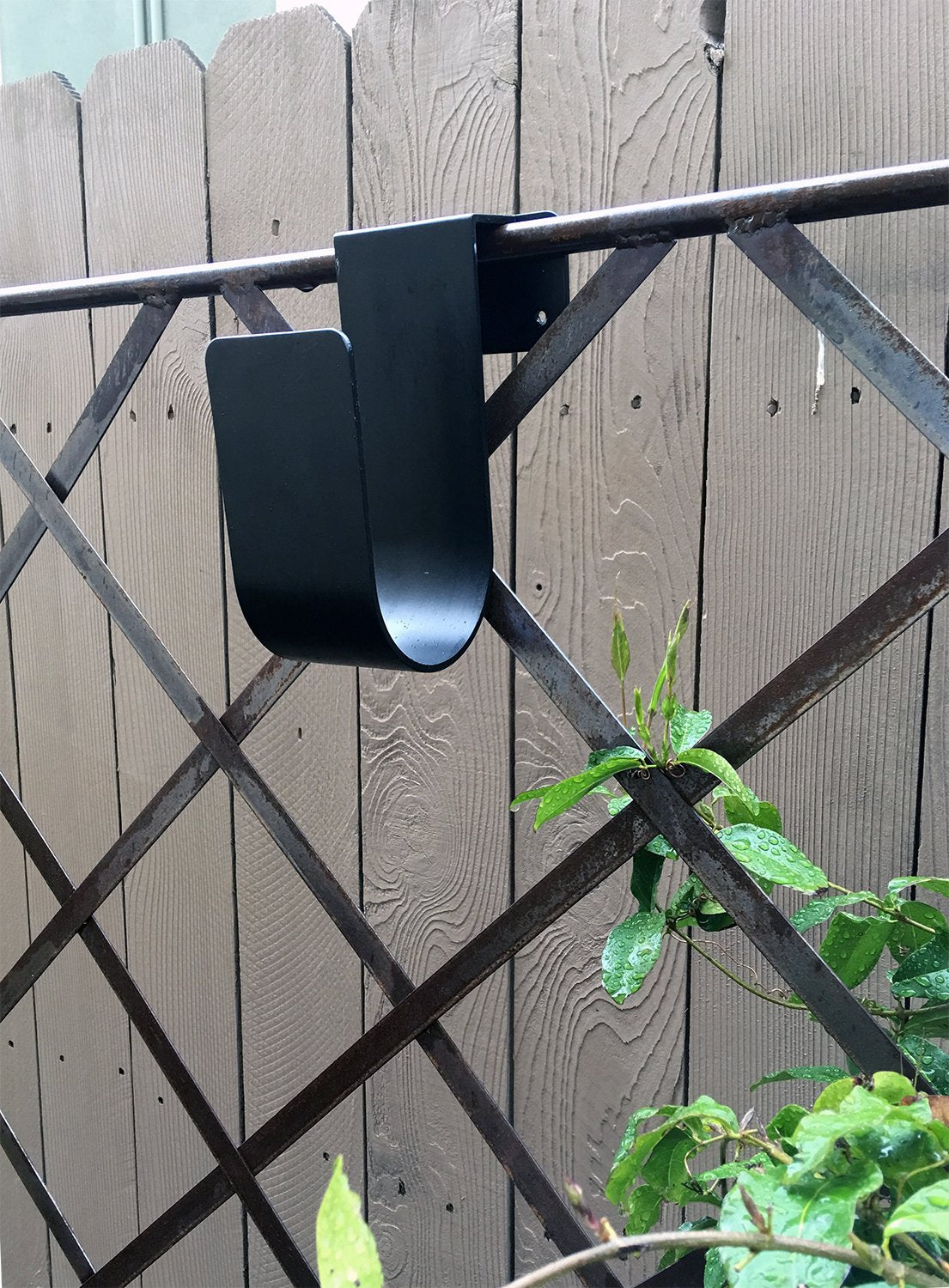 Poolmaster hose hanger mounts to solid surfaces for durable outdoor organization.