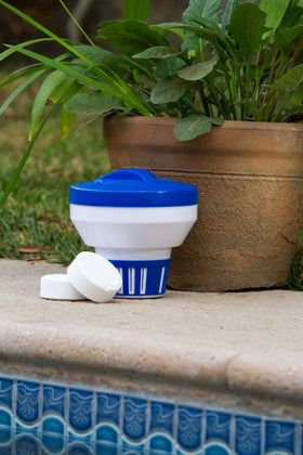 Poolmaster chlorine tablet holder cap secures refills with a twist-lock.