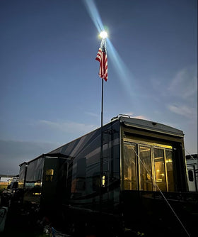PPQ Ivory Flag Light solar panel array powering long dusk-to-dawn glow