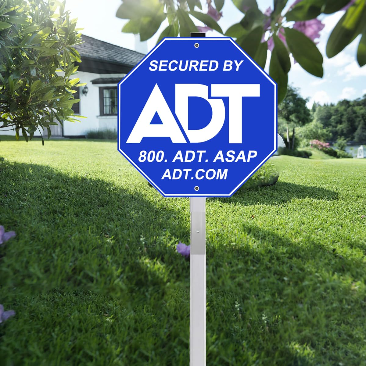 ADT security sign shown with blue-white design for maximum outdoor visibility