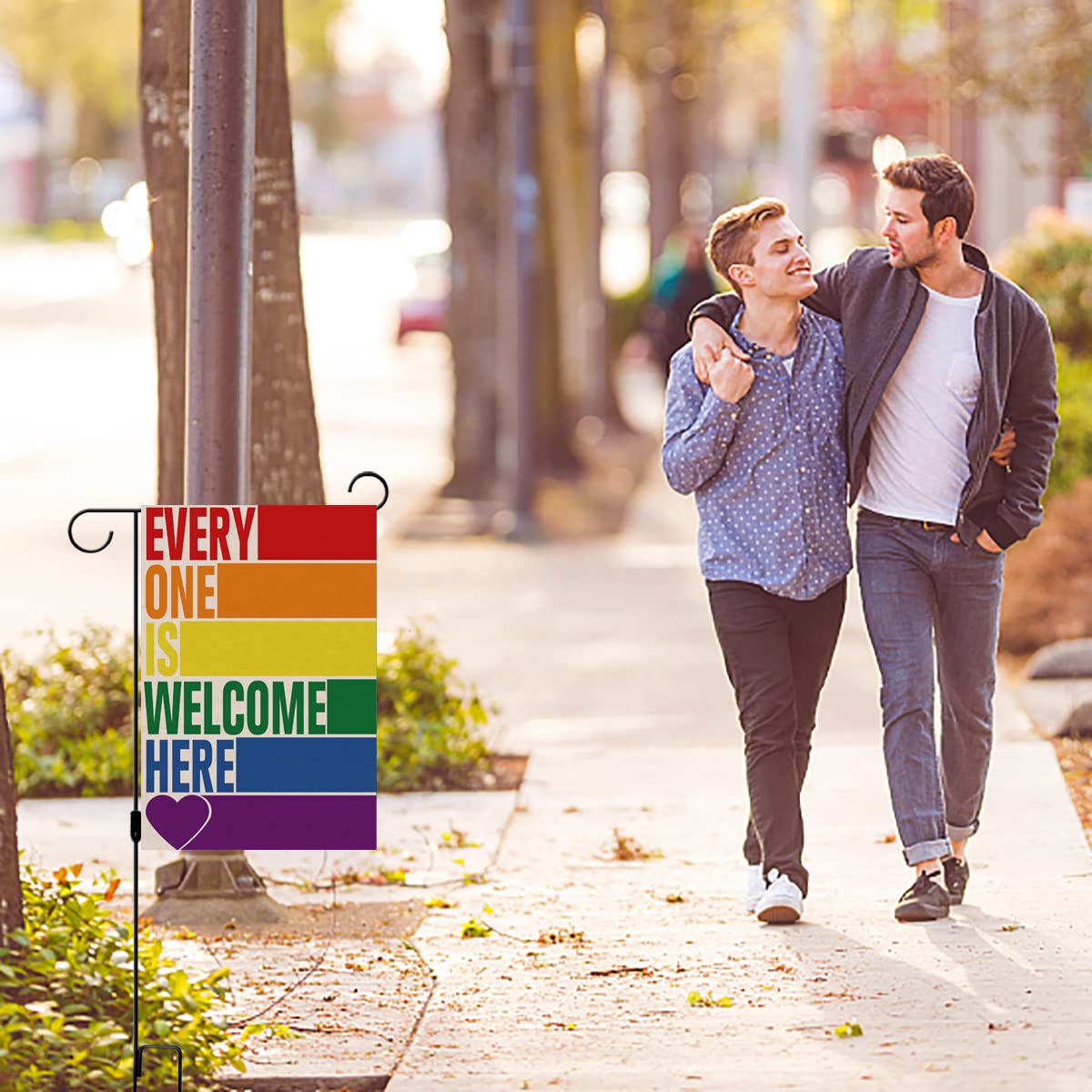 Pudodo Rainbow Welcome flag in garden setting boosts curb appeal.
