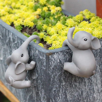 Pujipu elephant climbing planter hanger adds playful charm to outdoor pots.