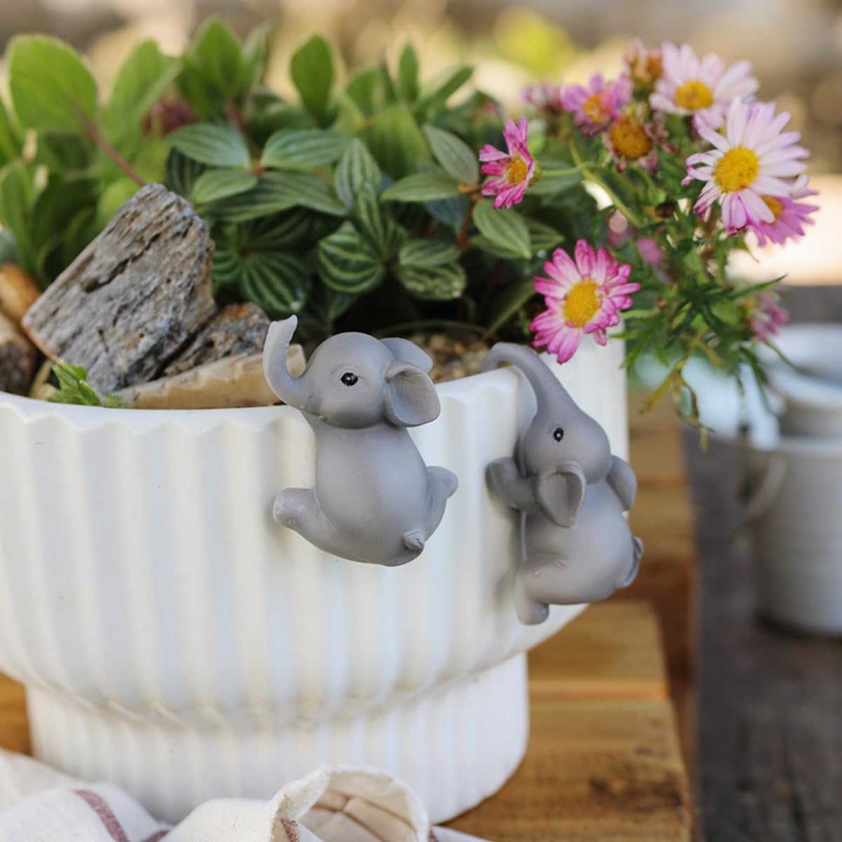 Pujipu funny pot hugger enhances indoor or fence planters with whimsy.