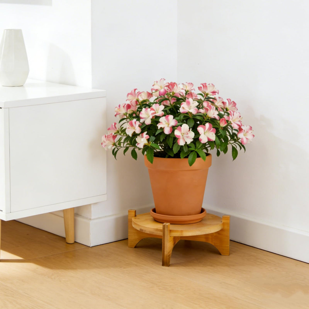 Pumtus indoor outdoor plant rack in natural bamboo finish.
