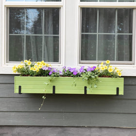 Pusonor brackets helping a balcony planter setup along a railing.