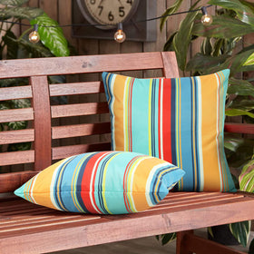 Pyonic blue stripe pillow cover demonstrates water resistance for patio use.