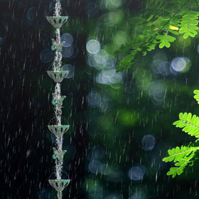 Qipade rain chain enhances garden entryways with decorative functionality.