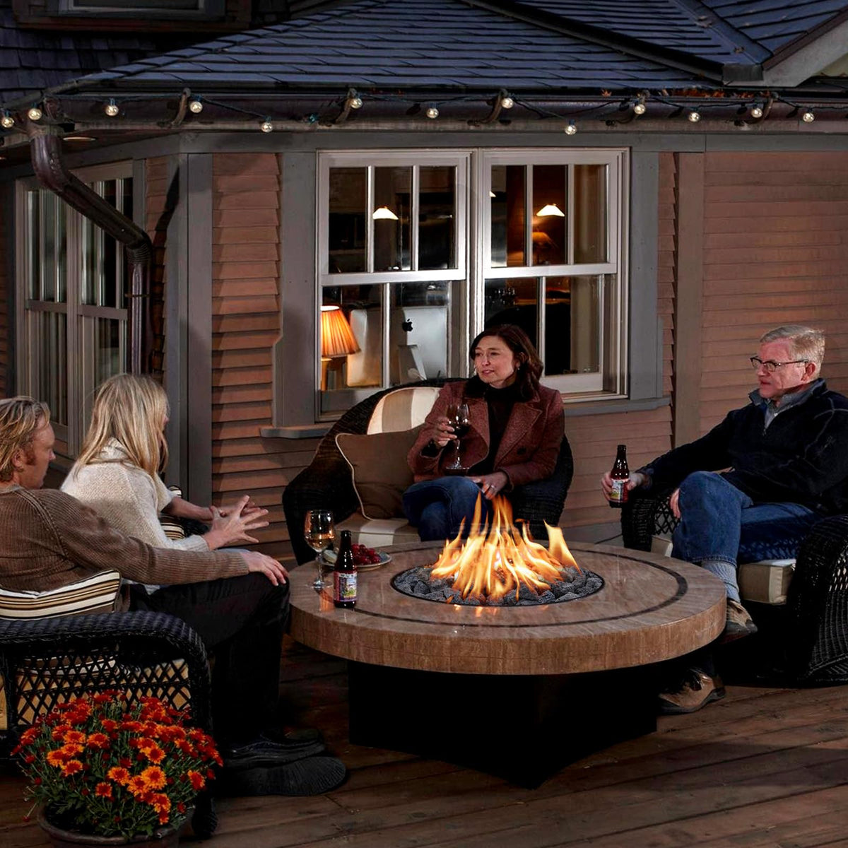Rahato fire pit rocks layered under flames provide aesthetic glow and heat retention.