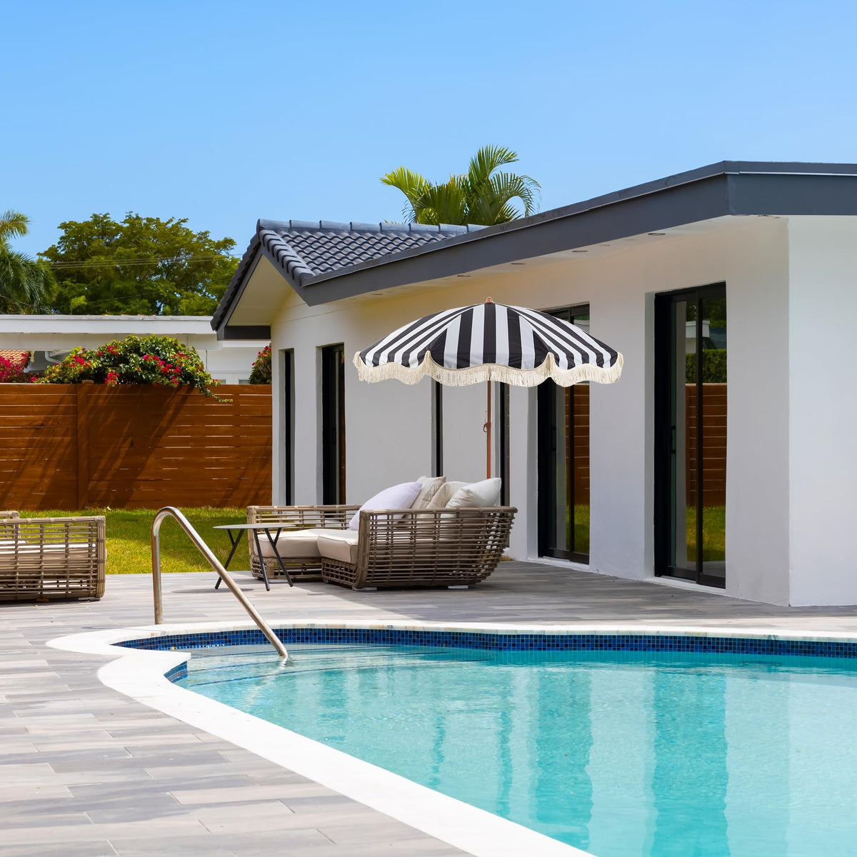 Rayjee fringe umbrella tilted for adjustable sun coverage during lounging