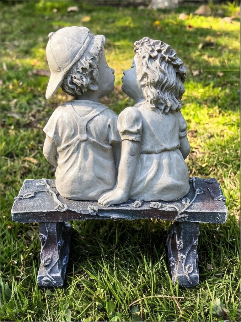 Rbhonb First Kiss statue shines in evening yard settings.