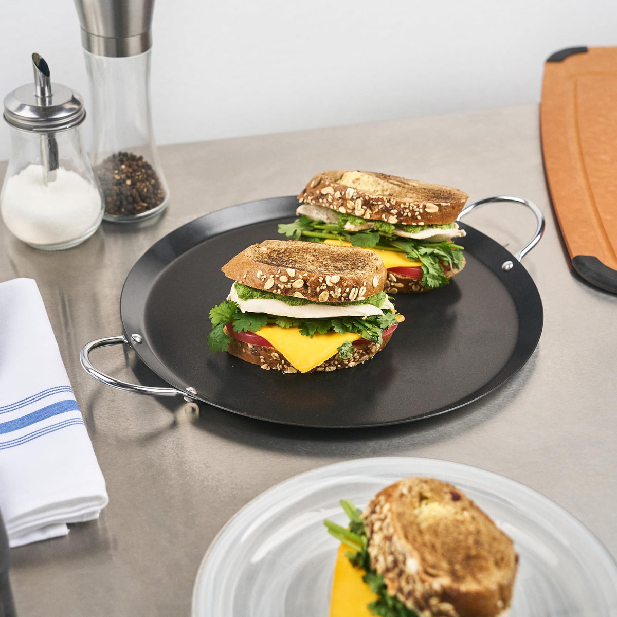 Restaurantware Met Lux chrome handles provide secure transport from stovetop to table
