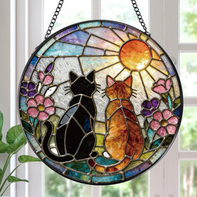 Rngmsi stained glass cat sun catcher on a window casts warm color light.
