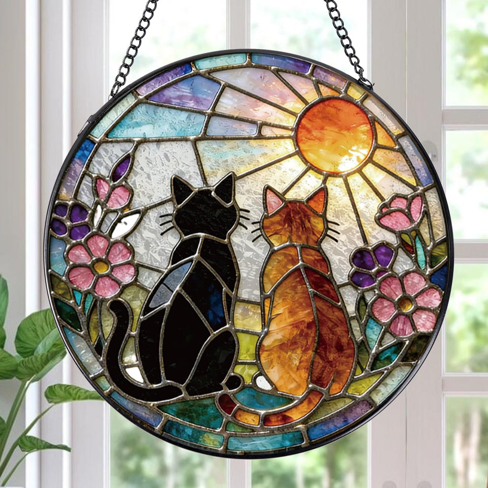 Rngmsi stained glass cat sun catcher on a window casts warm color light.