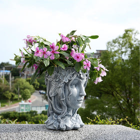 Romehaha face pot close-up reveals resin goddess design and smooth finish.