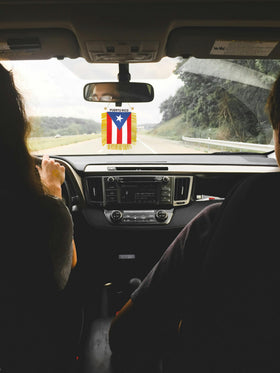 Rotenl Puerto Rico flag used as car or wall decor on a smooth surface.
