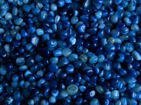 Royal Sapphire blue river rocks enrich garden beds with moisture retention and decorative color.
