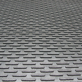 Rubber-Cal Dura-Scraper Linear close-up shows raised protrusions scraping dirt at the threshold.