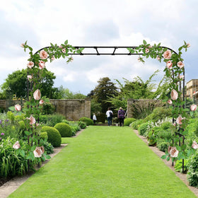 RUCOIN arch with climbing plants forms a vivid garden focal point