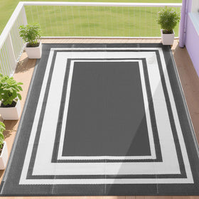 RURALITY outdoor rug on a grey-white patio, waterproof and fade-resistant