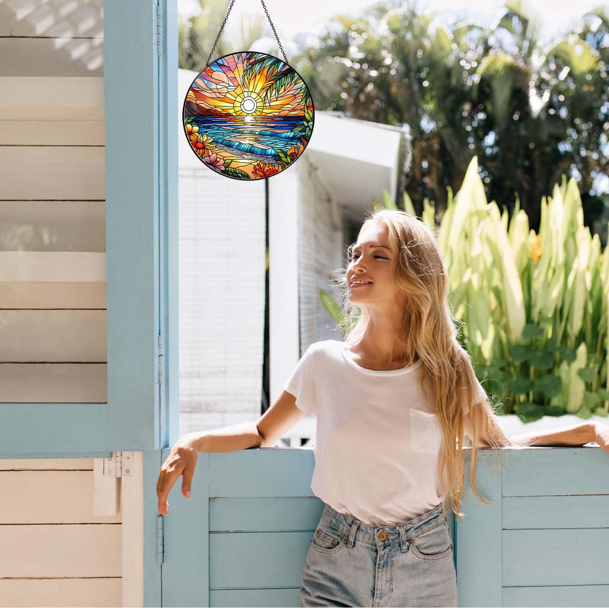 RVEAFA beach sunset suncatcher decorates balcony door with gentle refracted colors.