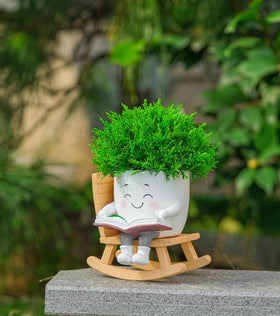 RZOIKZOI smiling face planter on rocking chair decorates patios and desks.