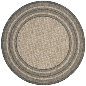 Safavieh Courtyard round natural black rug in outdoor setting withstands weather and preserves color