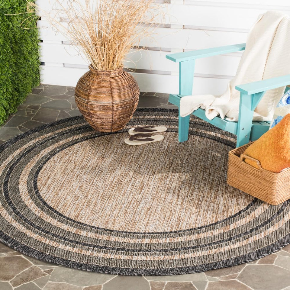 Safavieh Courtyard round natural black rug on patio for durable outdoor use