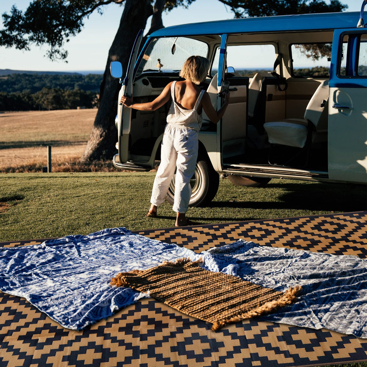 SAND MINE corner loops and stakes keep outdoor rug secure on ground.