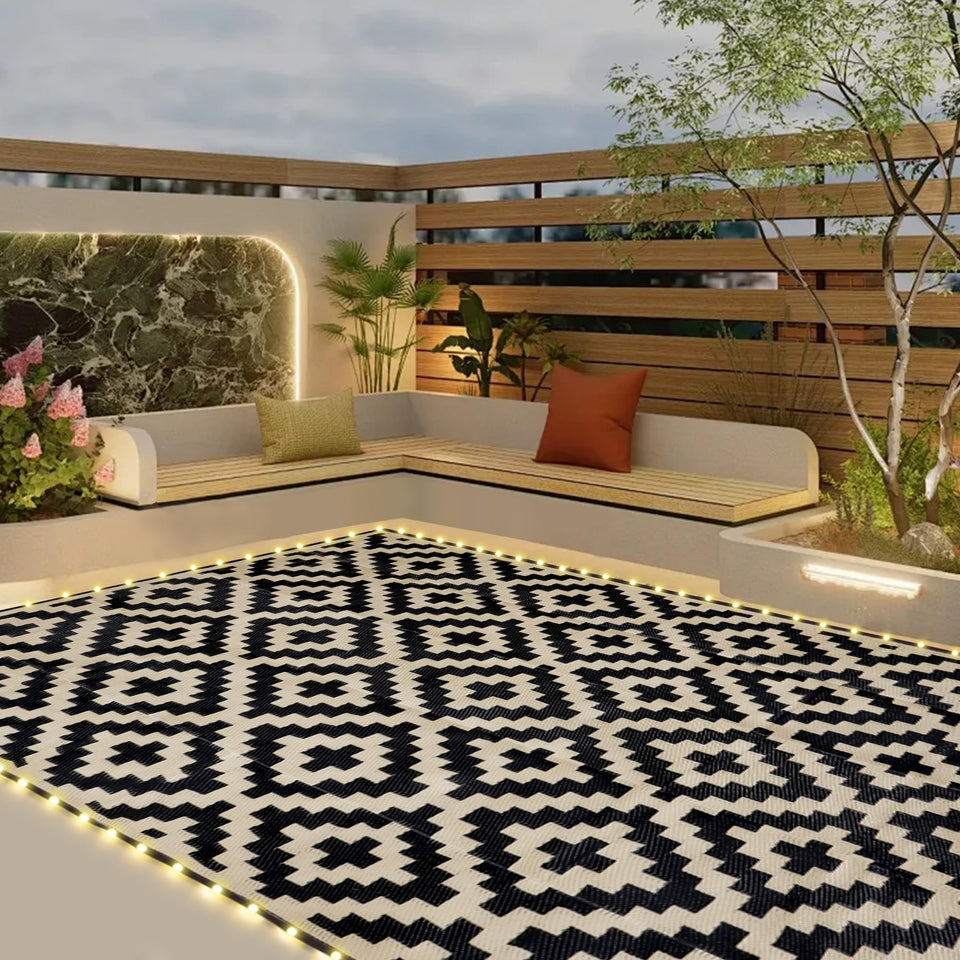 SAND MINE reversible mats with LED strips illuminate outdoor patios for cozy evenings.