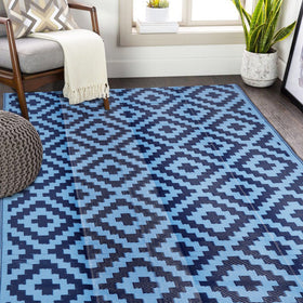 SAND MINE reversible mats in blue on a patio, durable and easy to clean.