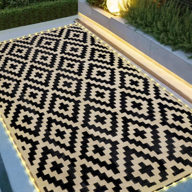 SAND MINE reversible mats with LED strip lighting for cozy patio evenings.