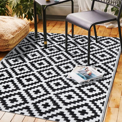 SAND MINE outdoor rug with black and white lattice on patio for durable outdoor use