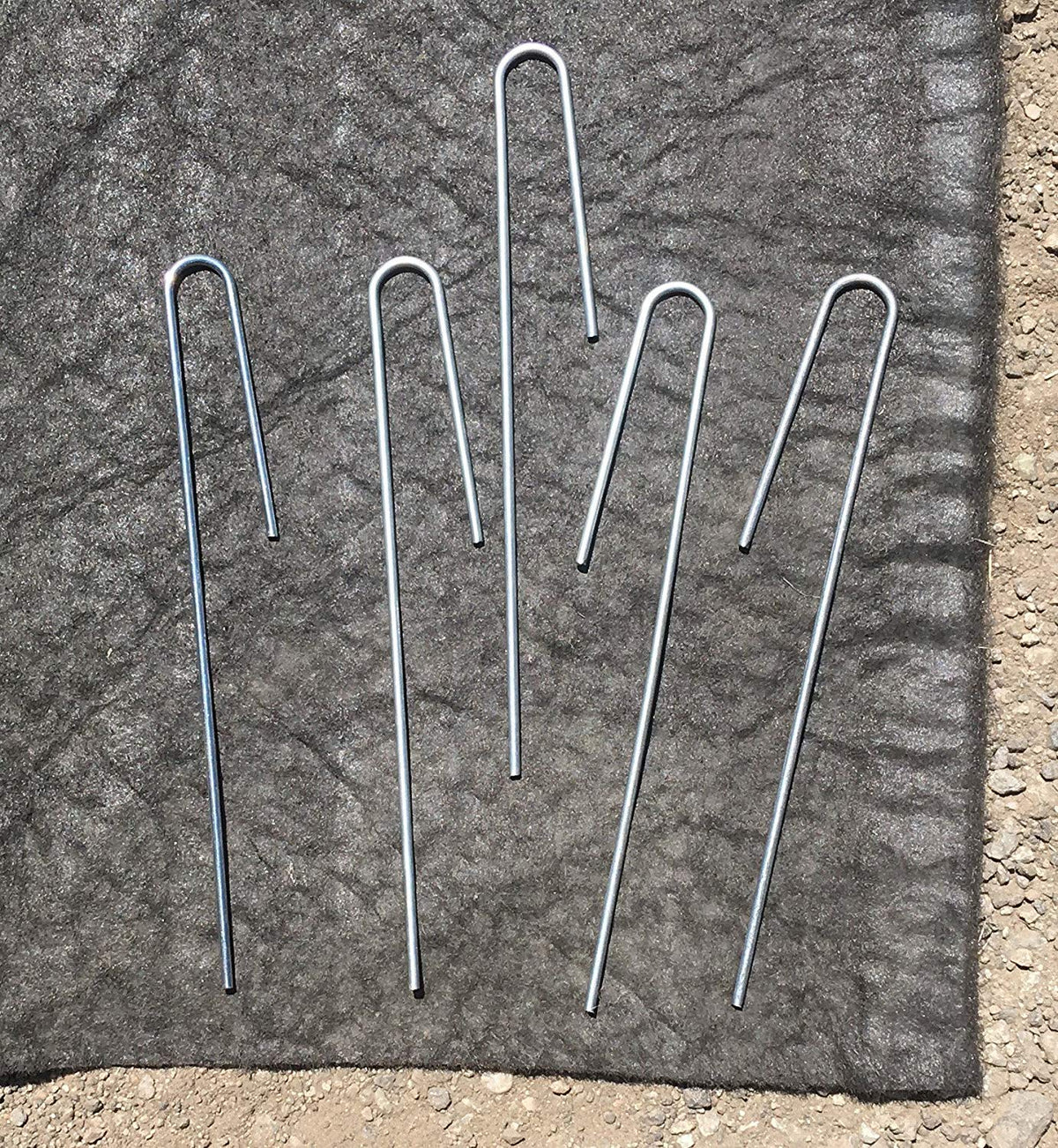 Sandbaggy durable-ground-holding-stake keeps tubing secure in uneven soil.