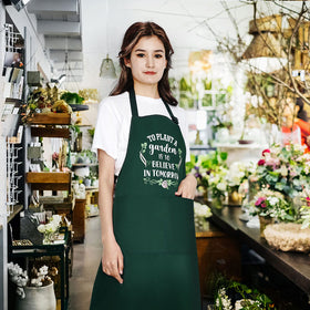 Saukore waterproof kitchen apron with large pockets for tools and recipes during cooking.