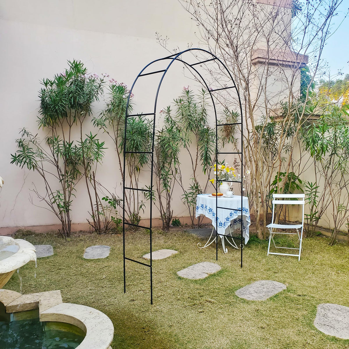 SCENDOR iron garden arch installed in a lush yard, ideal for climbing plants.