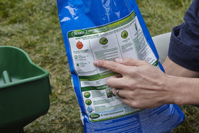 Scotts spreader applying Crabgrass Preventer for even lawn coverage