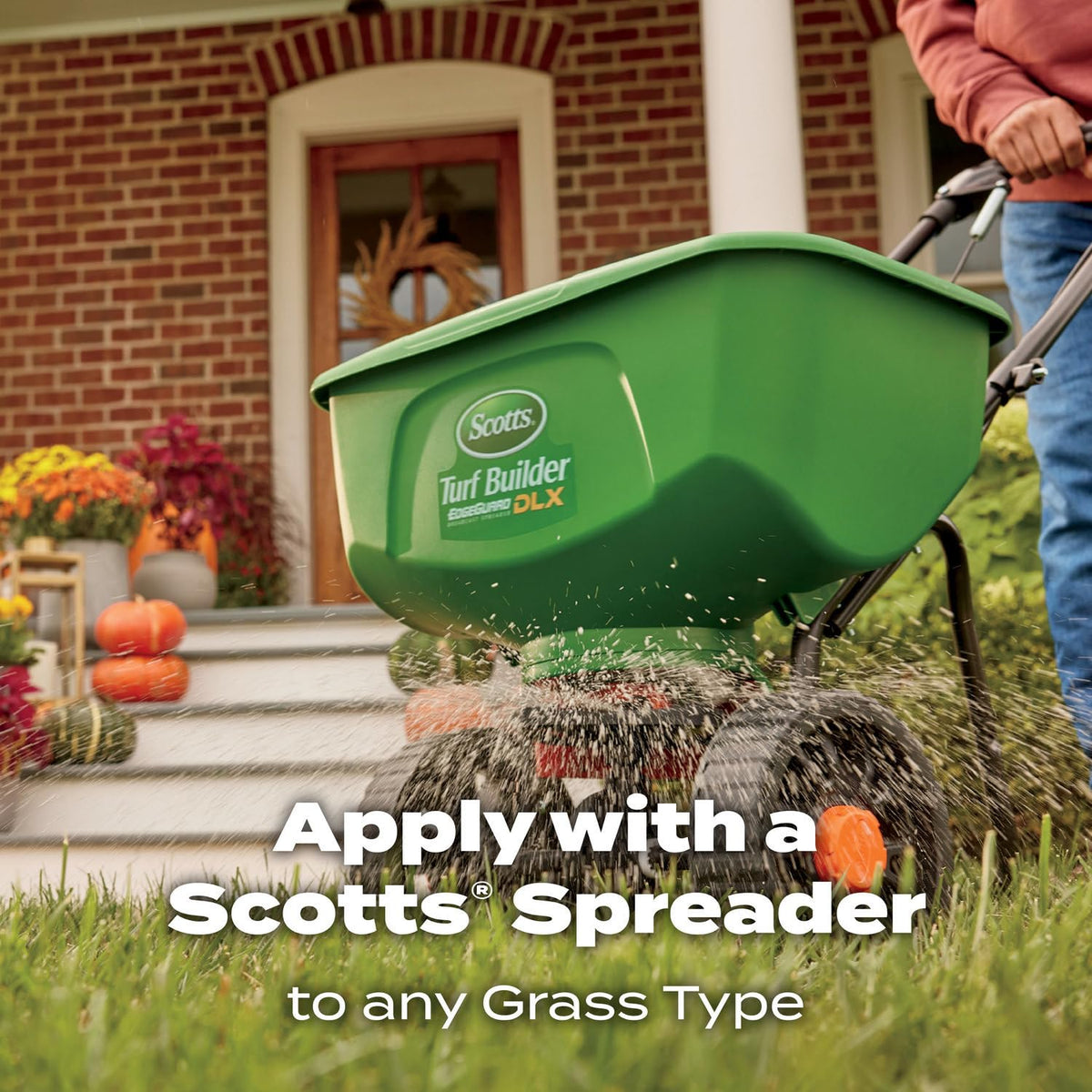 Dry lawn receiving Scotts WinterGuard fall feed for fall maintenance