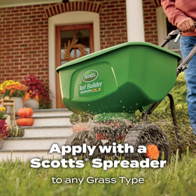 Dry lawn receiving Scotts WinterGuard fall feed for fall maintenance