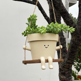 Scuyari swing planter brightens homes with a playful smiling character.