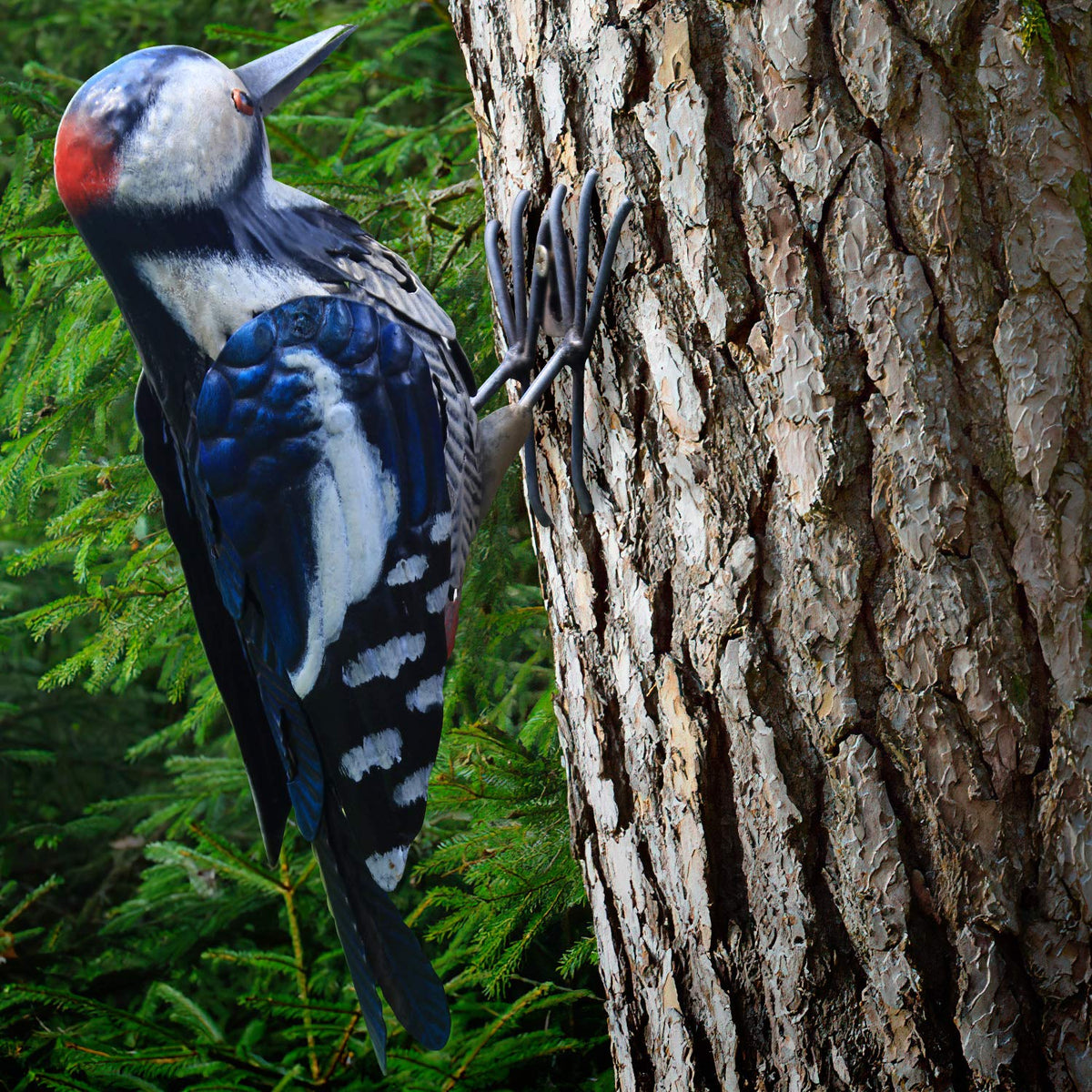 Shefio Metal Woodpecker Bird Figurine perched in garden adds durable outdoor charm.