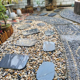 SHIZWU river rocks define borders and terraced plantings.