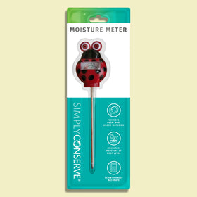 Simply Conserve Ladybug moisture meter used outdoors in a garden bed.