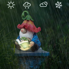 Sinhra gnome with warm LED glow enhances outdoor seating and ambience.