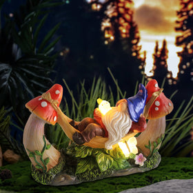 Sinhra gnome statue with mushrooms and bird adds whimsy to flower beds
