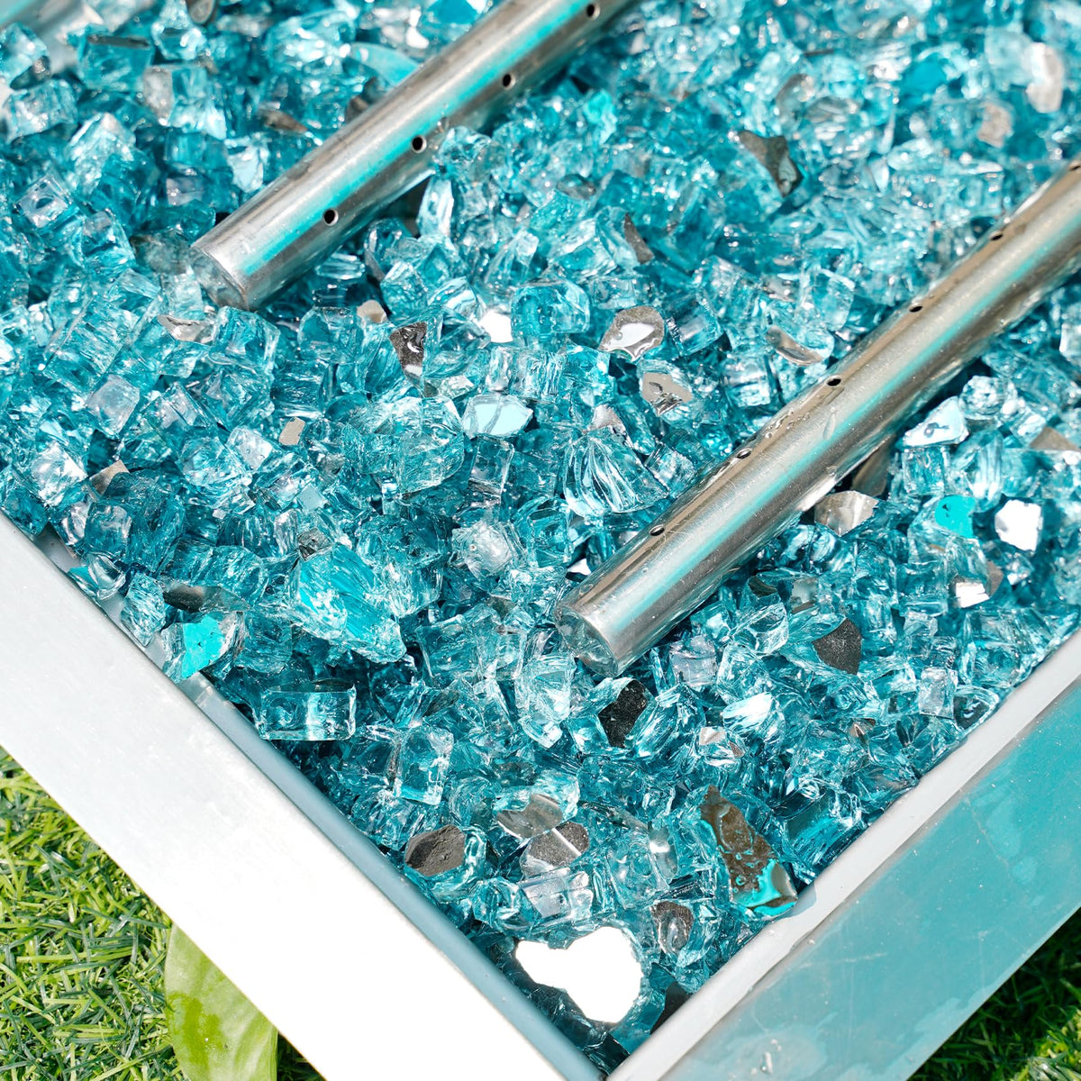 Skyflame aqua blue fire glass used as landscaping accent with shimmering appeal