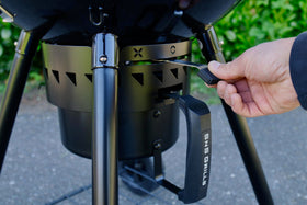 Slow 'N Sear Black Edition 22-inch ash removal system simplifies cleanup during grilling.
