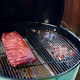 Slow N Sear XL two-zone setup on a kettle for versatile searing and smoking.