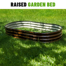 SnugNiture brown outdoor garden bed shown in a garden setting.