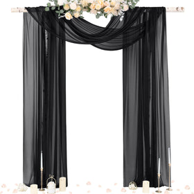 Socomi black sheer Gothic draping on an arch creating an elegant wedding backdrop.