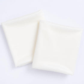 Socomi Ivory White fabric close-up highlights silky texture for elegant backdrops.